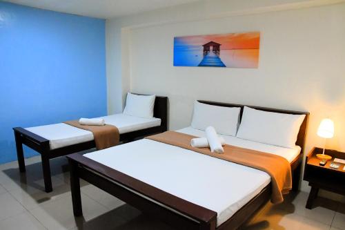 Postel nebo postele na pokoji v ubytování Arzo Hotel Makati