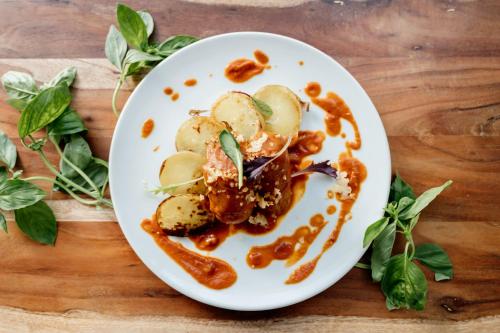 a white plate with food on a wooden table at Antico Convento Dei Cappuccini in Ragusa