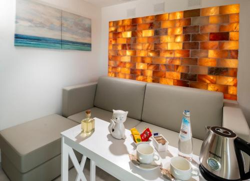 a living room with a table and a couch and a table and a table at Park Hotel Cattolica & Restaurant in Cattolica