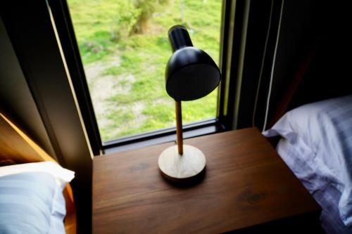 a lamp sitting on a table next to a window at EVEs POINT Private Villa in Guagua