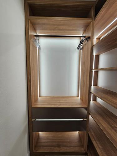 a closet with wooden shelves and a glass door at Luxury Apartment Ane in Zadar