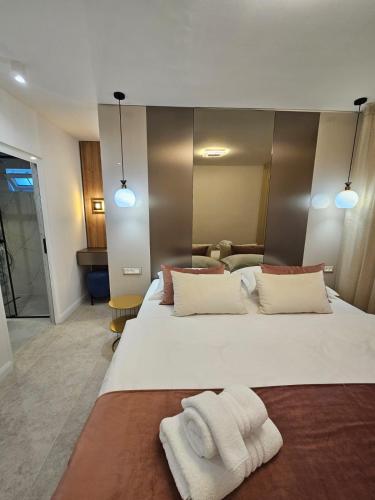 a bedroom with a large white bed with towels on it at Luxury Apartment Ane in Zadar