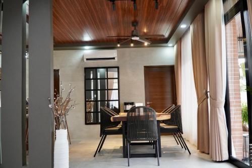 a dining room with a table and chairs at EVEs POINT Private Villa in Guagua