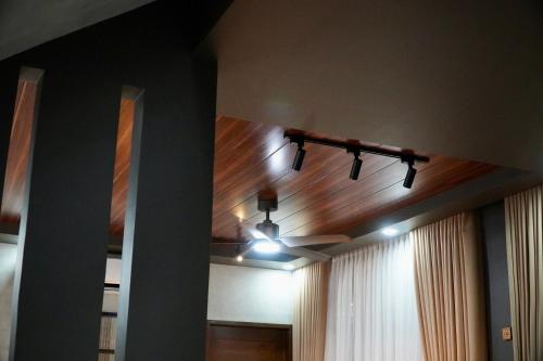 a room with a ceiling fan and a hallway at EVEs POINT Private Villa in Guagua