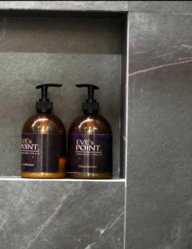 two bottles of soap sitting on a shelf at EVEs POINT Private Villa in Guagua