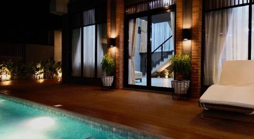a house with a swimming pool in a room with windows at EVEs POINT Private Villa in Guagua
