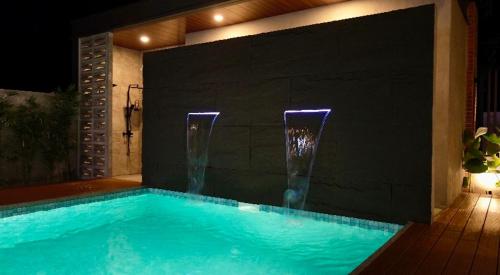 a swimming pool with two faucets and a swimming pool at EVEs POINT Private Villa in Guagua