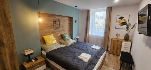 A bed or beds in a room at Péterfia Boutique Apartments