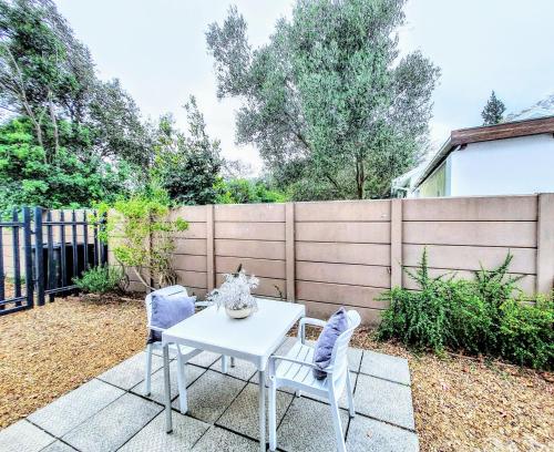 a patio with a white table and two chairs at 9 on Drommedaris in Stellenbosch