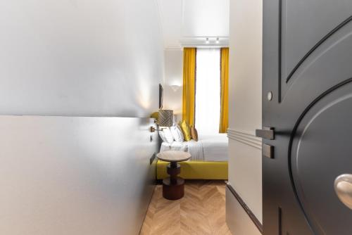 a small room with a bed and a window at The Couper Umiltà in Rome