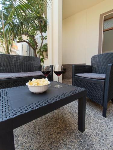 a table with a bowl of food and a glass of wine at Casa Iole in Dorgali
