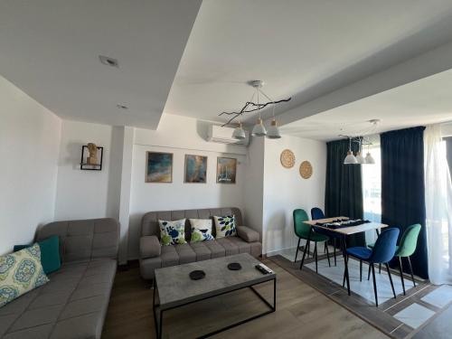 a living room with a couch and a table at Alta Vista Apollonia in Sozopol