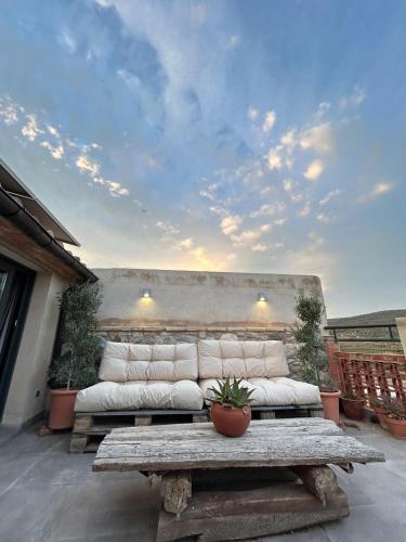 a couch sitting on a patio with a table at Ático con terraza en Capçanes in Capsanes