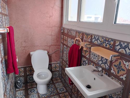 a bathroom with a toilet and a sink at Riad & Restaurant Ocean Beach Douira in Agadir