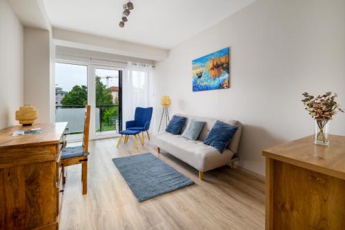 a living room with a couch and a table at Aranyhíd Apartman in Balatonföldvár