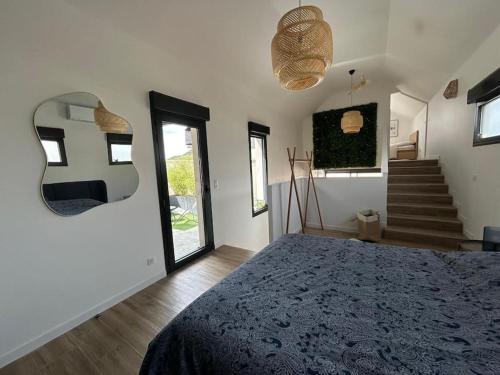 a bedroom with a bed in a room with stairs at LOFT & SPA, aux Portes de Disneyland et de Paris in Saint-Thibault-des-Vignes
