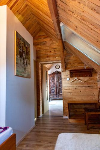 a room with wooden walls and wooden ceilings at Agroturystyka Hanka i Jurek in Boruja