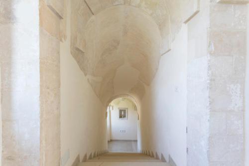 an aisle in a building with a ceiling at Antico Convento Dei Cappuccini in Ragusa