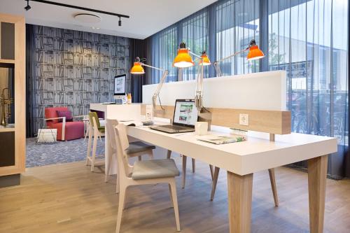 an office with a desk with a laptop on it at Holiday Inn Berlin City East Side by IHG in Berlin