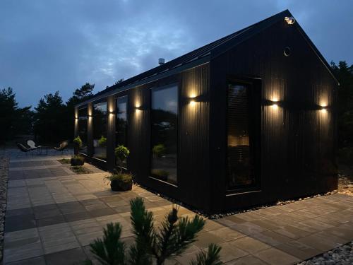 a black house with a lot of windows at Seaside Rendezvous 2 in Kalana