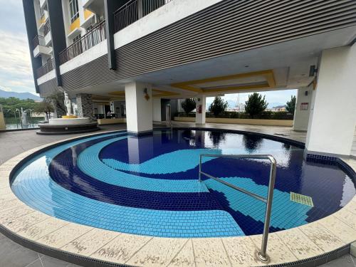 a large swimming pool in the middle of a building at The Majestic Executive Suite - Ipoh in Ipoh