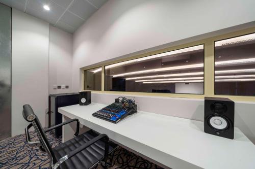 an office with a desk with a keyboard and speakers at Radisson Hotel Riyadh Airport in Riyadh