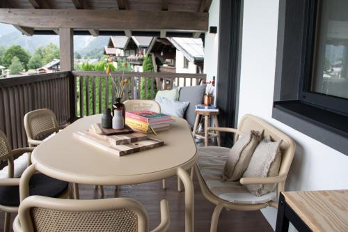 a table and chairs on a balcony with a table and a table at Schönblick Appartements in Lofer