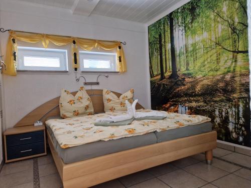 a bedroom with a bed with a painting on the wall at Ferienwohnung Am Öpitzer Berg in Pößneck