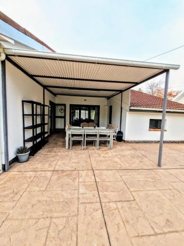 awning over a patio with a table on it at 9 on Drommedaris in Stellenbosch