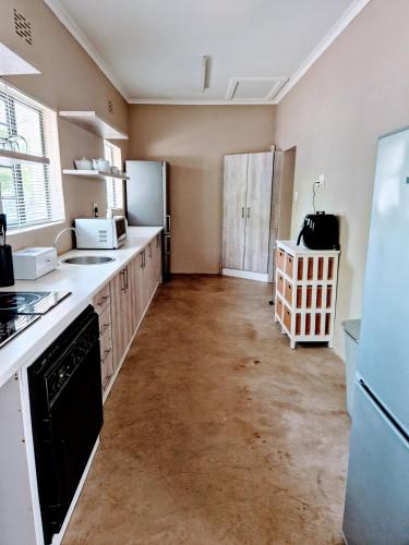 a kitchen with a refrigerator and a stove top oven at 9 on Drommedaris in Stellenbosch