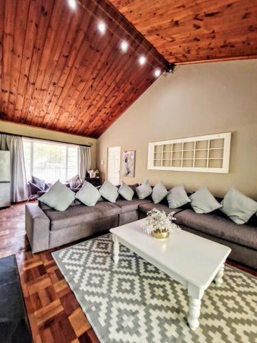 a living room with a couch and a table at 9 on Drommedaris in Stellenbosch