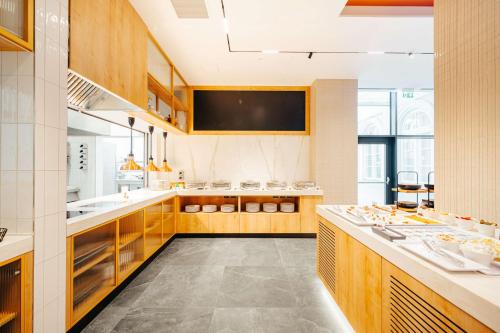 a large kitchen with wooden cabinets and a large counter at Hilton Garden Inn Radom in Radom