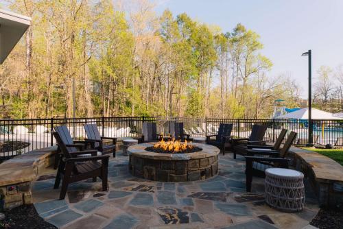 a patio with chairs and a fire pit at Embassy Suites By Hilton Gatlinburg Resort in Gatlinburg