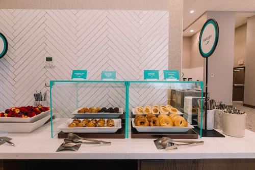 a display case with donuts on a counter in a store at Embassy Suites By Hilton Gatlinburg Resort in Gatlinburg