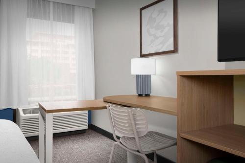 a hotel room with a desk and a chair at Spark By Hilton San Antonio Northwest Near Six Flags in San Antonio