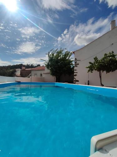 a large blue swimming pool in front of a building at Casa do Duque in Arneiro