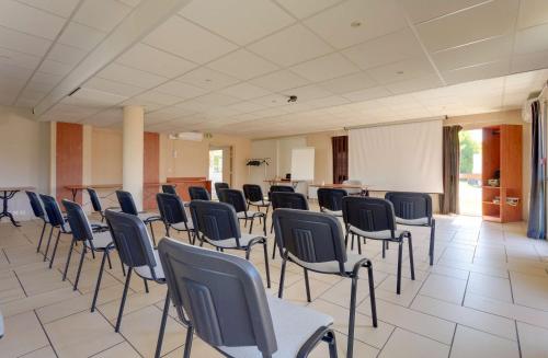 a large room with chairs and tables in it at Brit Hotel Reims La Pompelle in Reims
