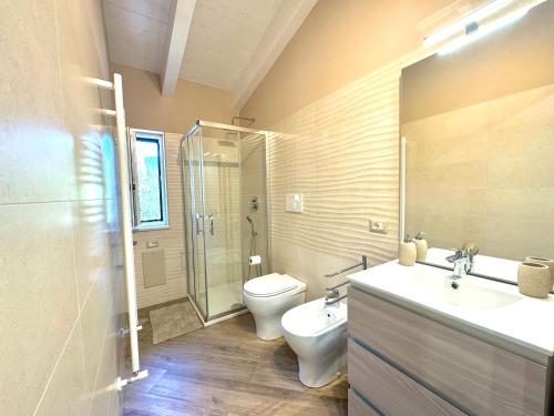 a bathroom with a toilet and a sink and a shower at Dolce Risveglio in Agerola
