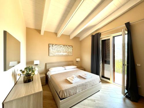 a bedroom with a bed and a large window at Dolce Risveglio in Agerola