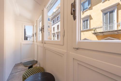 a room with a door and a window at The Couper Umiltà in Rome