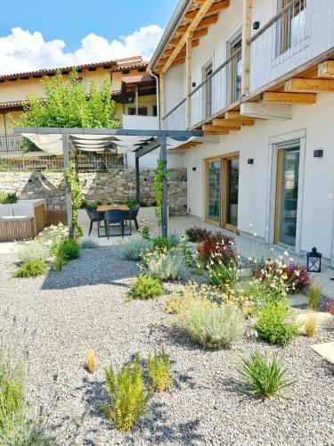 a garden with a patio and a house at Casa Matko in Kostanjevica na Krasu
