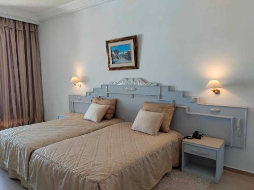 a bedroom with a large bed with a blue headboard at Amir Palace in Monastir