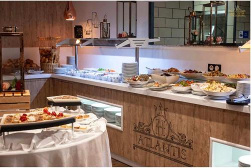a buffet line with many plates of food on it at Atlantis Alger in Alger