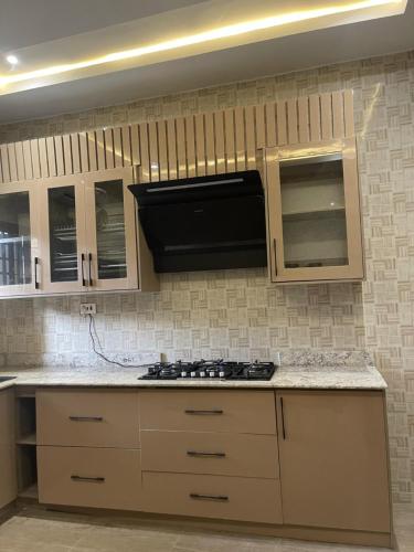 a kitchen with a stove top oven in a kitchen at Charming 3-Bed House in Kubwa in Kaba