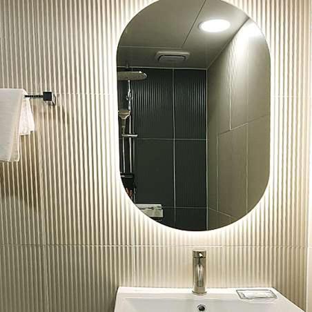 a bathroom with a mirror and a sink at Penatess Pool Villa in Chungju