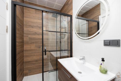 a bathroom with a shower and a sink and a mirror at Villa Central in Dalyan