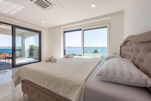 A bed or beds in a room at Seaview Villa A`More with heated pool