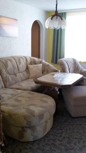 a living room with a couch and a coffee table at Ferienwohnung-Ullmann in Ehrenfriedersdorf