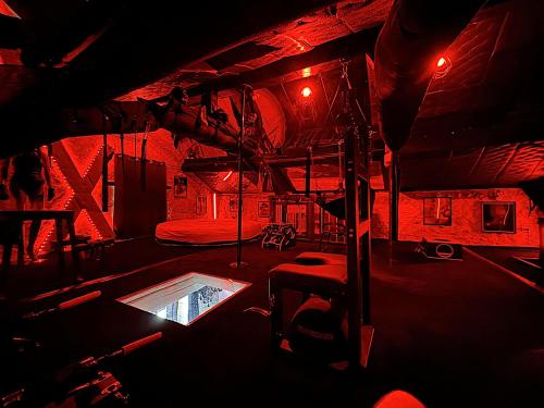 a room with a swimming pool in a room with red lights at Caporizon-Lov'BNB-La seule Love House de Dordogne in Biras