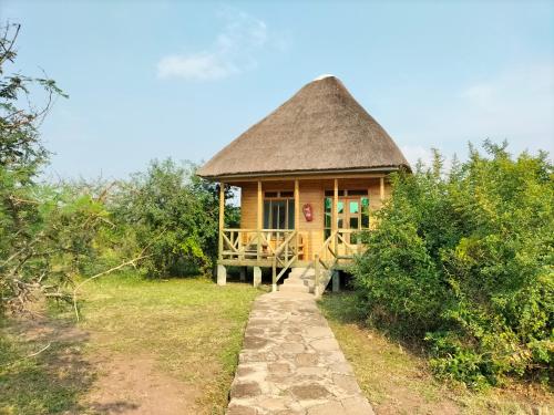 a small hut with a thatched roof at Engiri Game Lodge and Campsite in Katunguru